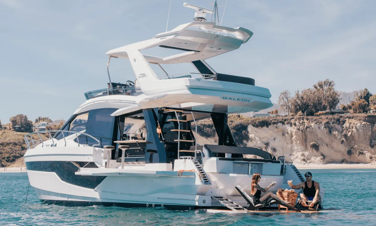 Andiamo at anchor with guests on the swim platform