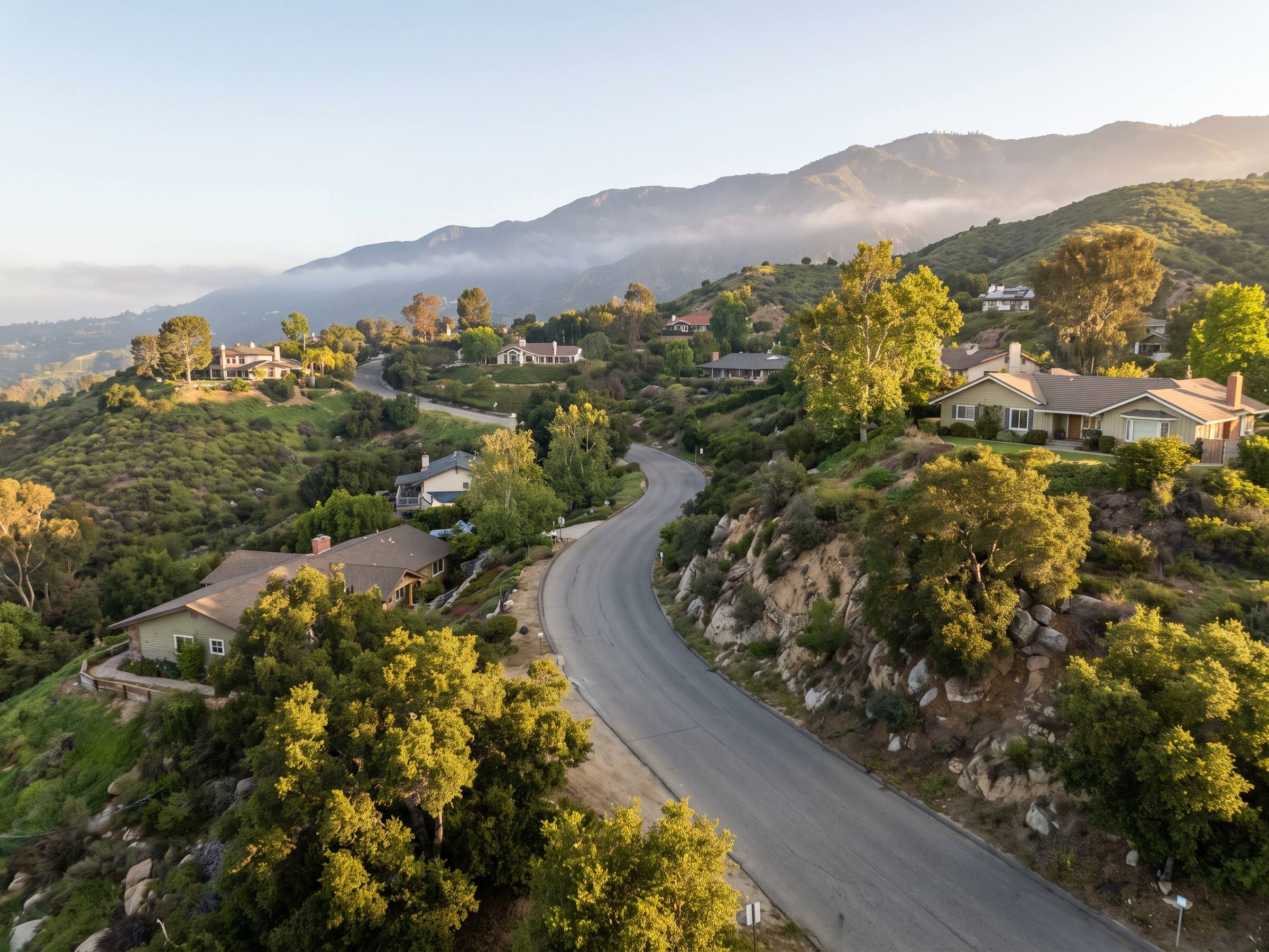 Homes set against the San Gabriel foothills in golden light